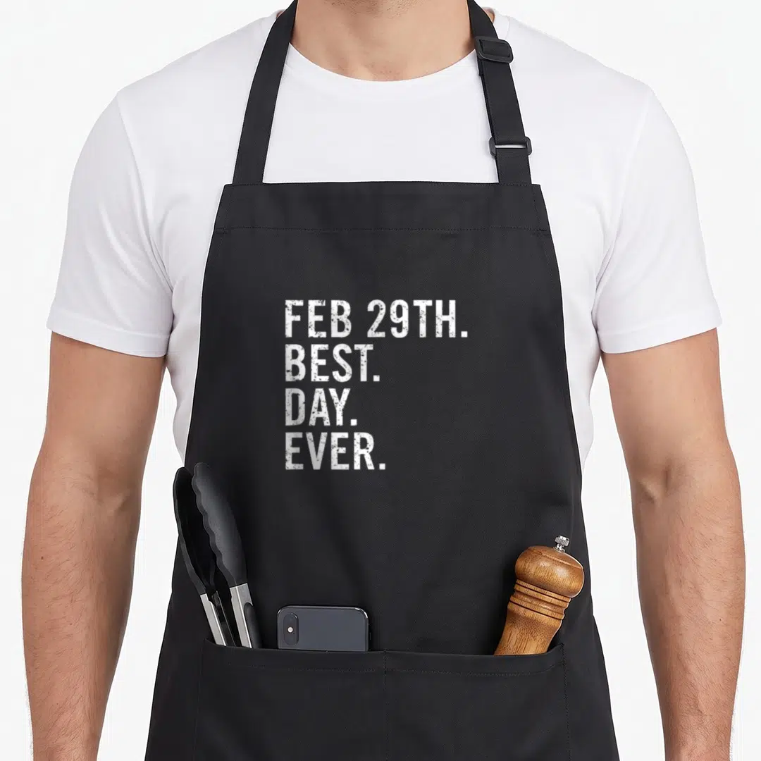 29th leap birthday apron - White stacked text reading FEB 29TH. BEST. DAY. EVER — shown on a black cotton canvas apron against a white background