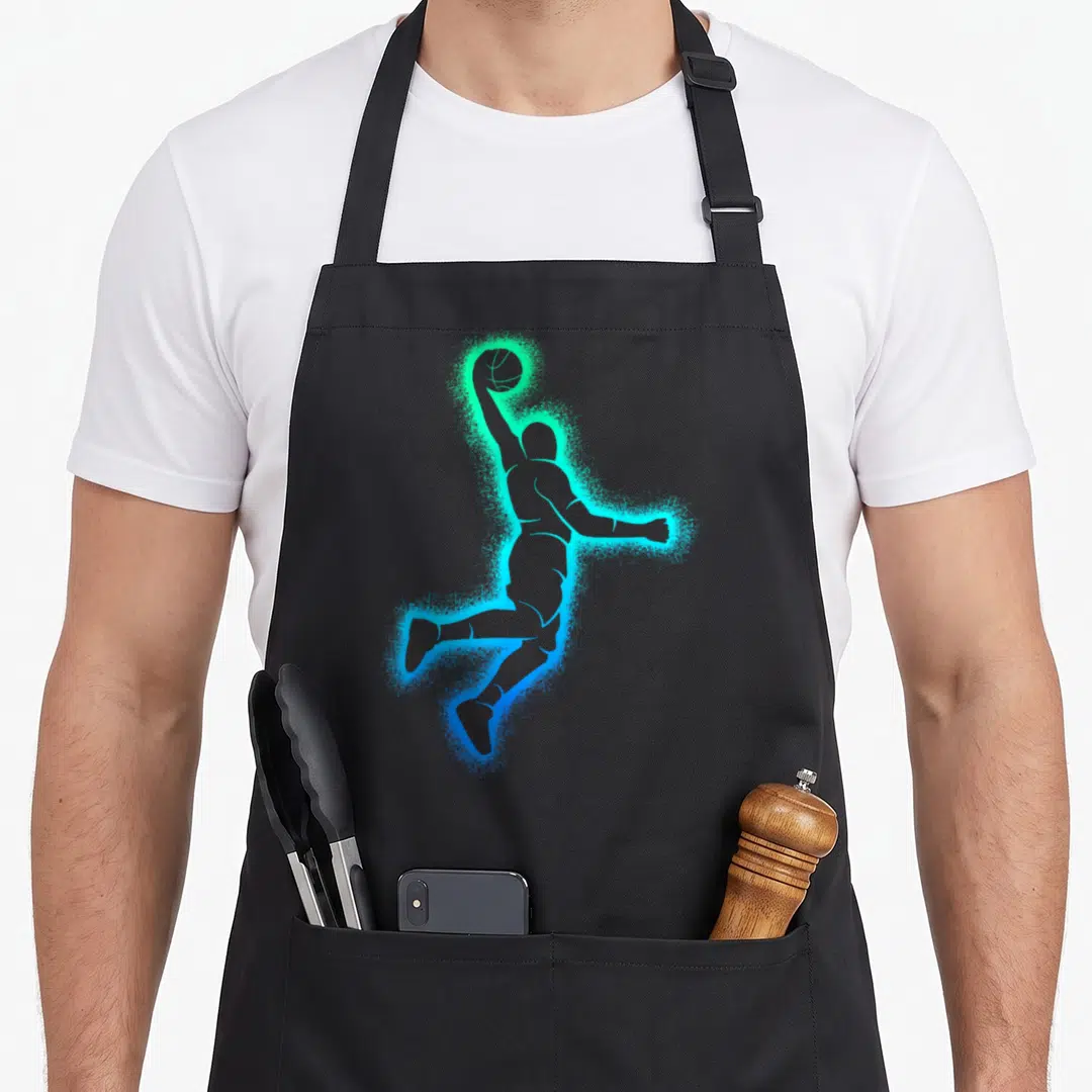Dunking basketball player apron - Minimalist silhouette of a jumping basketball player outlined in glowing blue — shown on a black cotton canvas apron against a white background