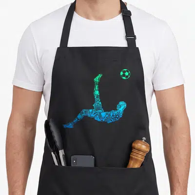 Funny player soccer apron - Blue and green composite silhouette of soccer player bicycle kick with floating ball — shown on a black cotton canvas apron against a white background