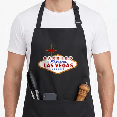 Married maid apron - Retro diamond sign reading Married in Fabulous Las Vegas Nevada with red star — shown on a black cotton canvas apron against a white background