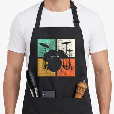 Drummer drum set apron - Grey drum kit silhouette over teal beige yellow and orange squares — shown on a black cotton canvas apron against a white background