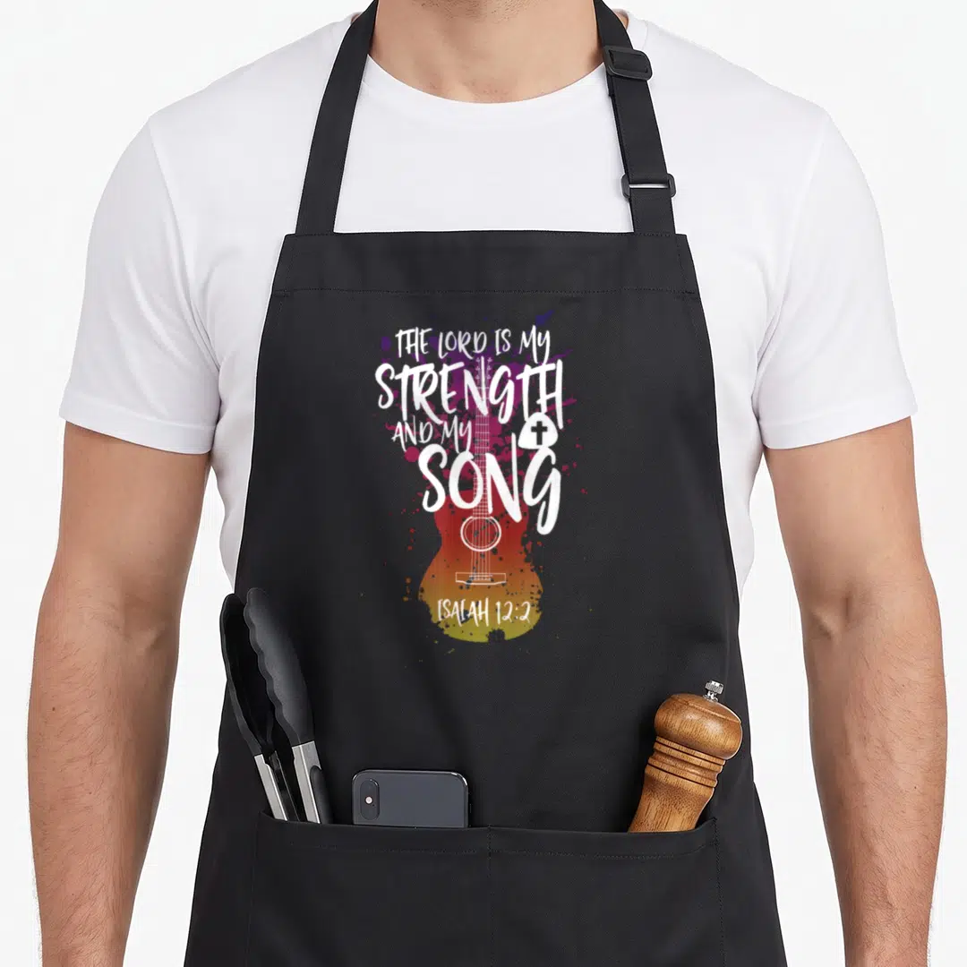 Music guitar christian apron - White guitar outline with Isaiah 12:2 text and purple red orange splatters — shown on a black cotton canvas apron against a white background