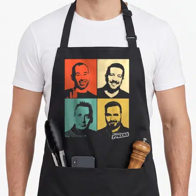Impractical fools apron - Four retro male portraits on red beige teal and yellow backgrounds with (IMPRACTICAL) JOKERS — shown on a black cotton canvas apron against a white background