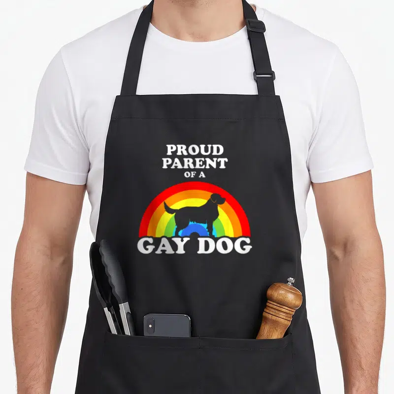 Dog gay pride apron - Proud Parent of a Gay Dog text over blue dog silhouette and rainbow arc — shown on a black cotton canvas apron against a white background
