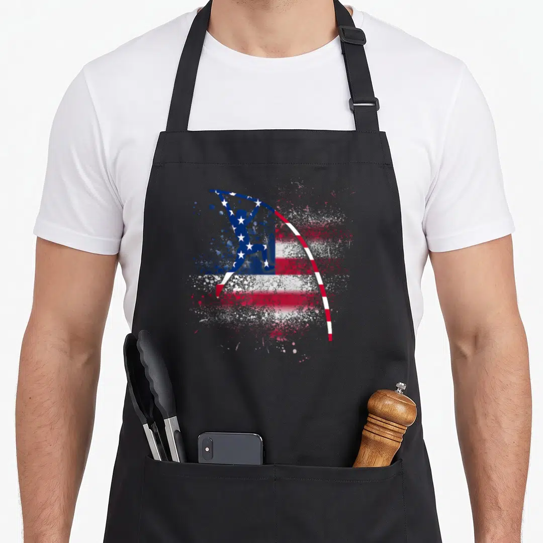Vaulting patriotic apron - Pole vaulter silhouette in red white blue distressed flag pattern — shown on a black cotton canvas apron against a white background