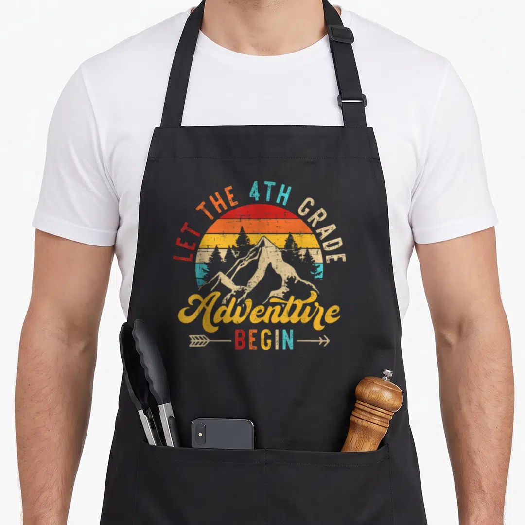 Adventure begin teacher apron - Retro mountain inside striped sun with 'LET THE 4TH GRADE Adventure BEGIN' text — shown on a black cotton canvas apron against a white background