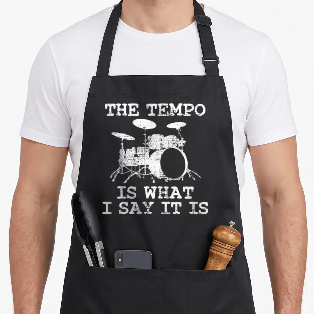 Drum trumpeter apron - Distressed white drum kit flanked by text reading THE TEMPO IS WHAT I SAY IT IS — shown on a black cotton canvas apron against a white background