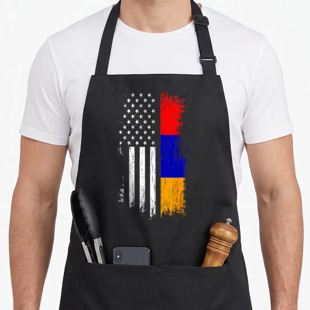Armenia american flag apron - Distressed US and Armenian flags side by side in white red blue and orange — shown on a black cotton canvas apron against a white background