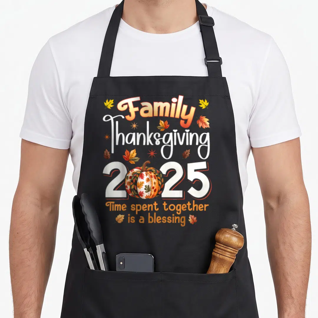 Family crew thanksgiving aprons - Patterned pumpkin inside 2025 with leaves and blessing quote — shown on a black cotton canvas apron against a white background
