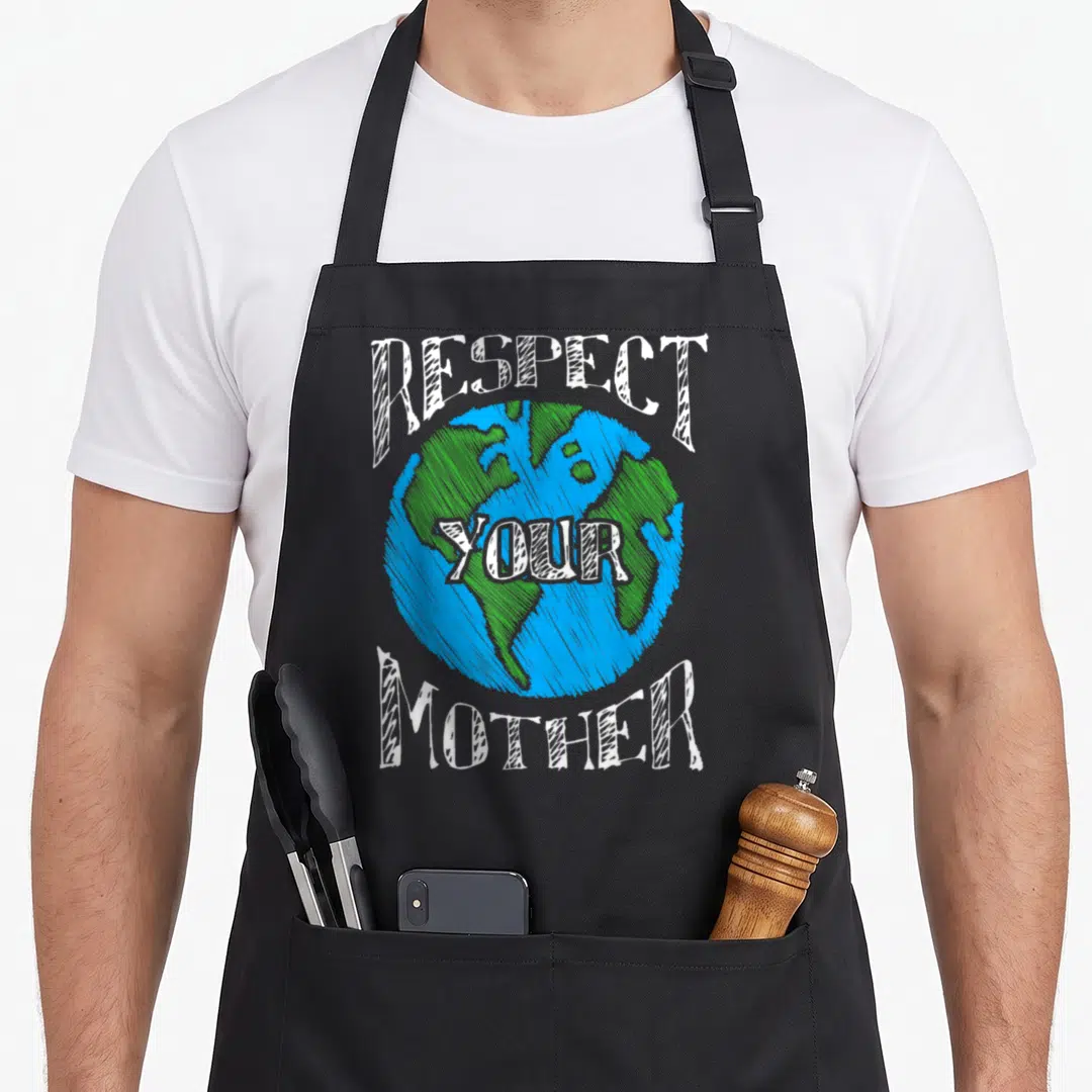 Mother change apron - Cartoon Earth globe with Respect Your Mother text in blue and green sketch style — shown on a black cotton canvas apron against a white background