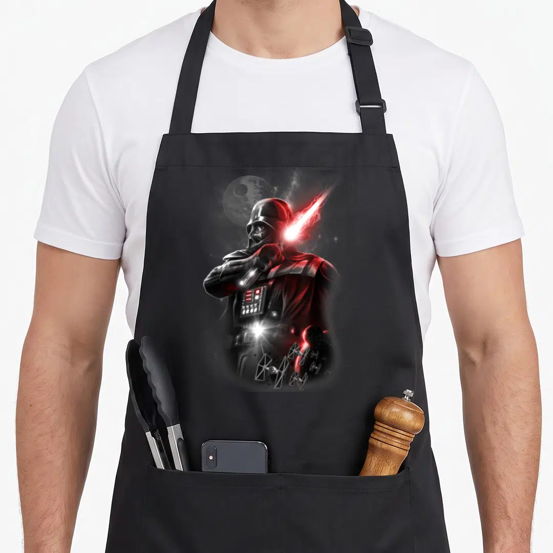 Portrait general apron - Realistic Darth Vader holding red lightsaber with Death Star and TIE fighters on grey — shown on a black cotton canvas apron against a white background