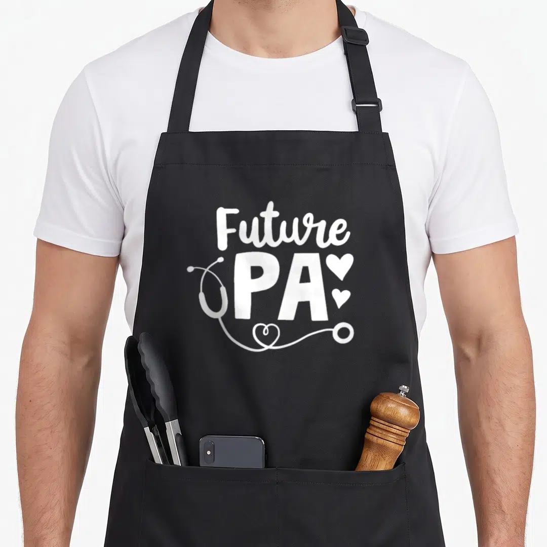Future assistant doctor apron - White Future PA text with stethoscope and three hearts on grey background — shown on a black cotton canvas apron against a white background