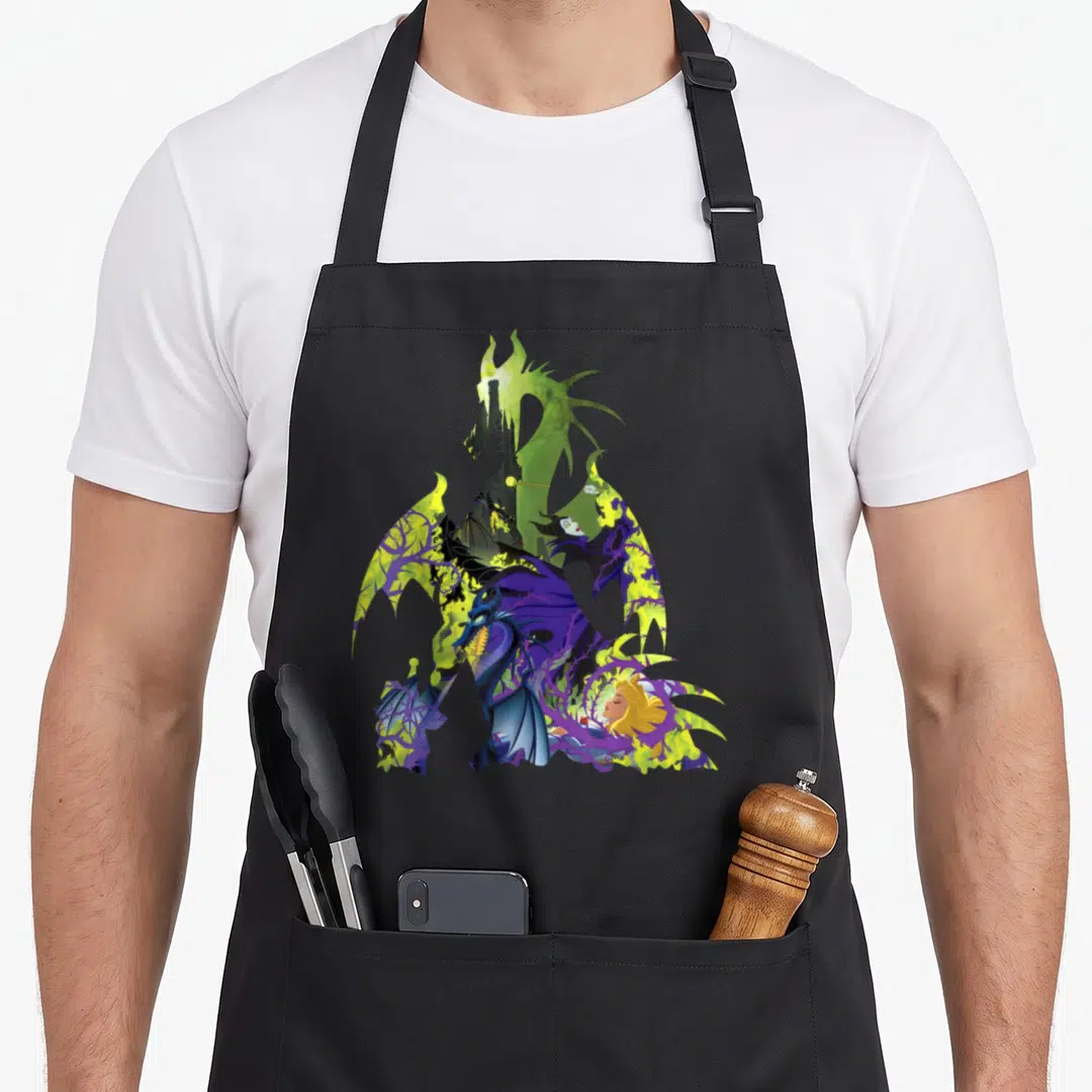 Dragon beauty apron - Maleficent dragon silhouette containing Aurora and castle with thorns in purple and green cartoon — shown on a black cotton canvas apron against a white background