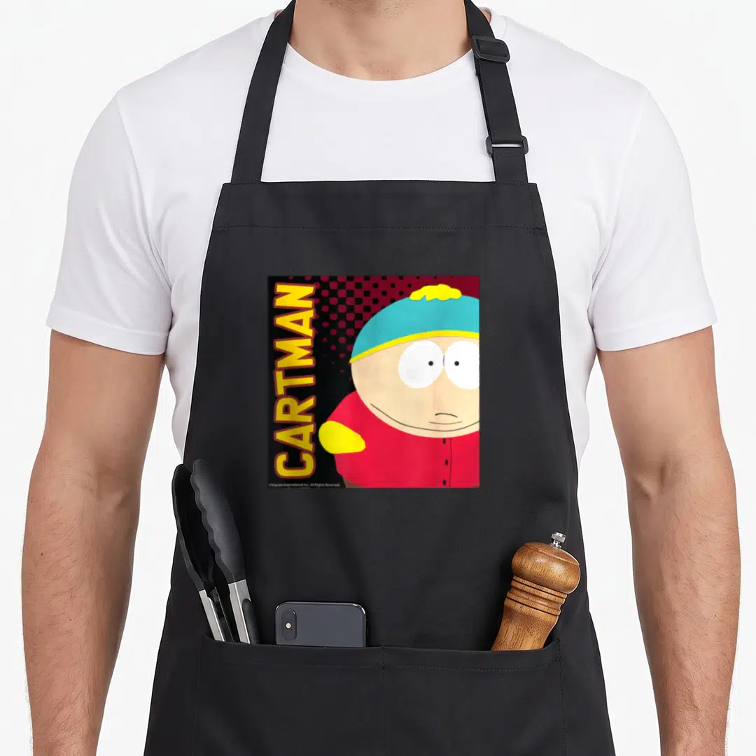 Cartman deep south apron - Vertical yellow CARTMAN text beside Eric Cartman in red shirt and blue hat — shown on a black cotton canvas apron against a white background