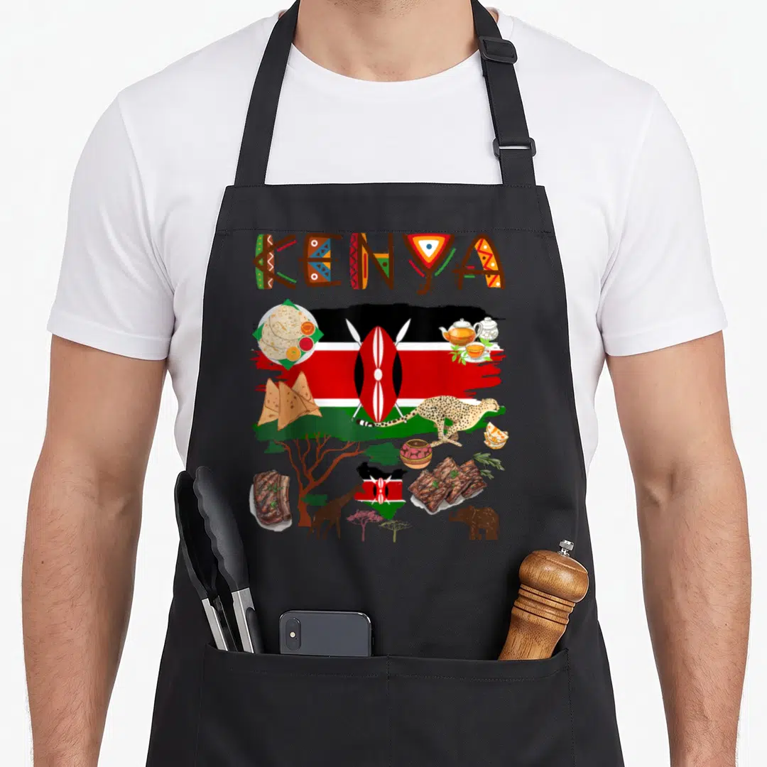 Flag food aprons - KENYA text with flag shield, food, cheetah, giraffe, elephant, and map in red green black brown — shown on a black cotton canvas apron against a white background