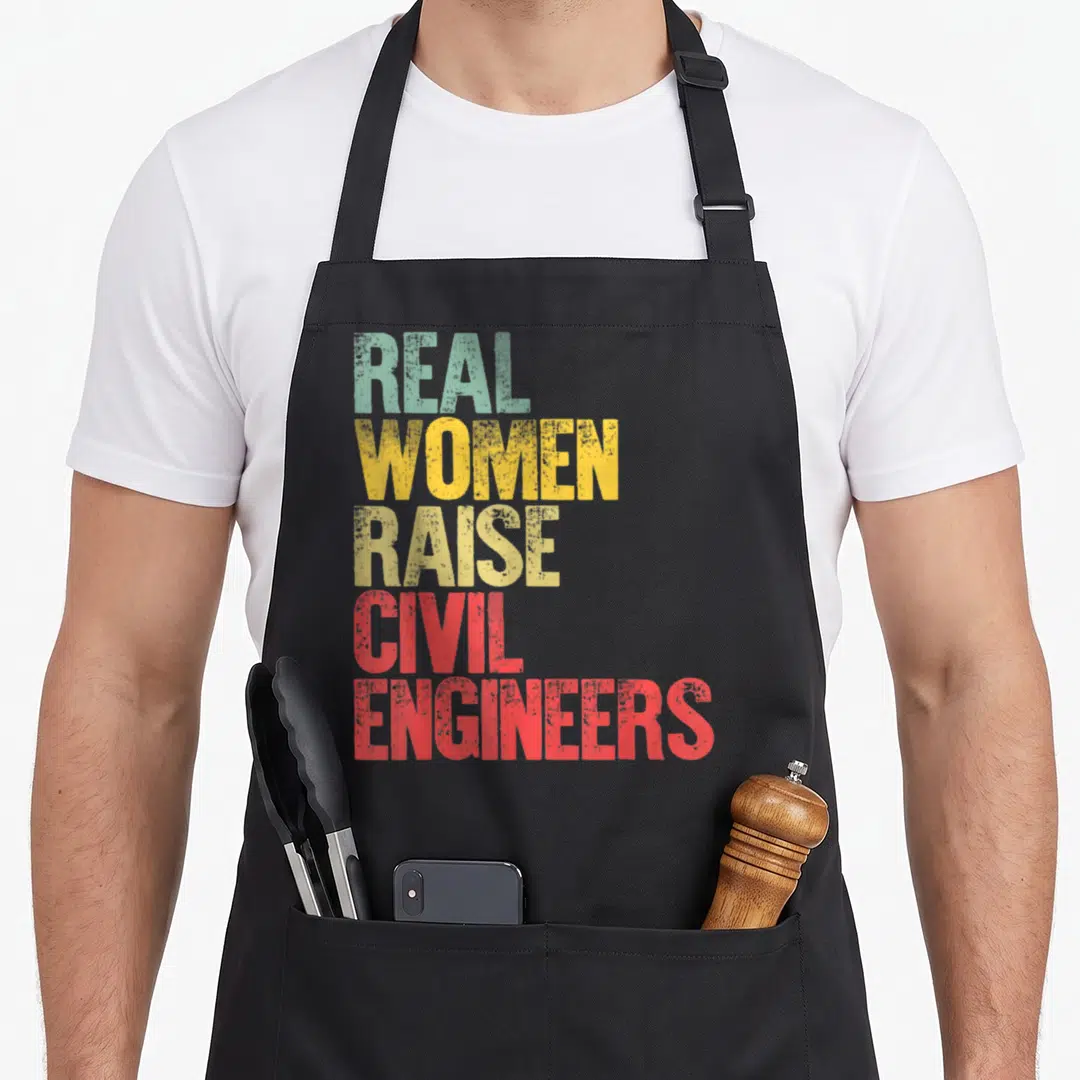 Proud civil engineer apron - Stacked text reading REAL WOMEN RAISE CIVIL ENGINEERS in teal yellow and red — shown on a black cotton canvas apron against a white background
