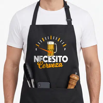 Mexican beer apron - Beer mug on fuel gauge with NECESITO Cerveza text in orange and white — shown on a black cotton canvas apron against a white background