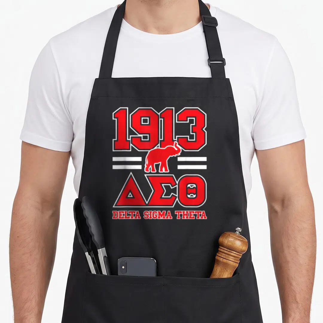 Paraphernalia sorority apron - Red 1913 text above elephant between white lines and Delta Sigma Theta Greek letters — shown on a black cotton canvas apron against a white background