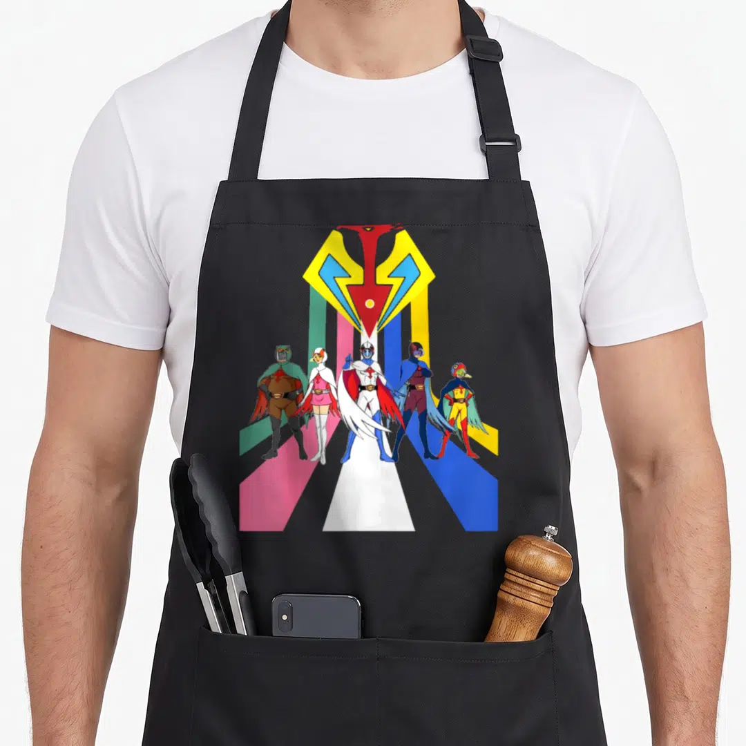Gatachaman planet apron - Five cartoon superheroes under yellow-red logo with colored vertical stripes — shown on a black cotton canvas apron against a white background