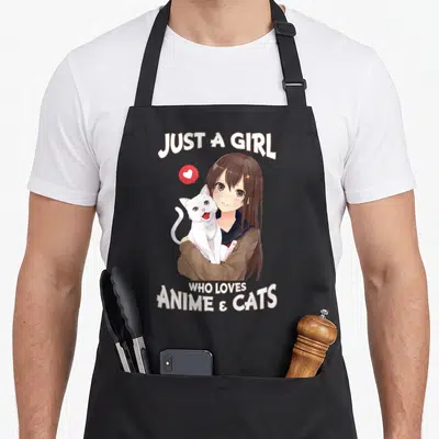 Cat japan apron - Girl holding white cat with Just A Girl Who Loves Anime & Cats text — shown on a black cotton canvas apron against a white background