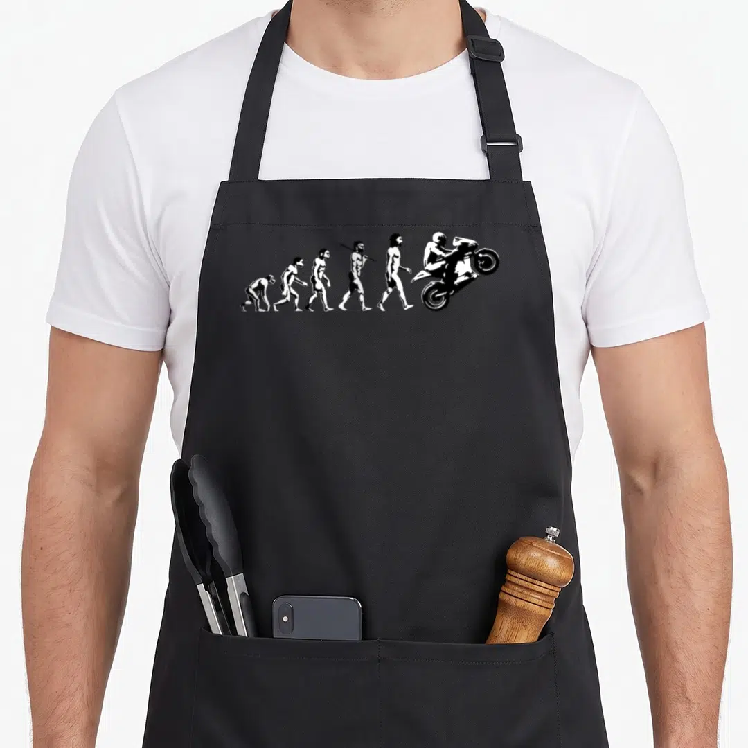 Race bike apron - White evolution of man sequence ending in motorcycle wheelie silhouette — shown on a black cotton canvas apron against a white background