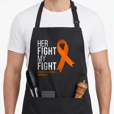 Fight msemen apron - Stacked white text Her Fight My Fight next to orange MS awareness ribbon — shown on a black cotton canvas apron against a white background
