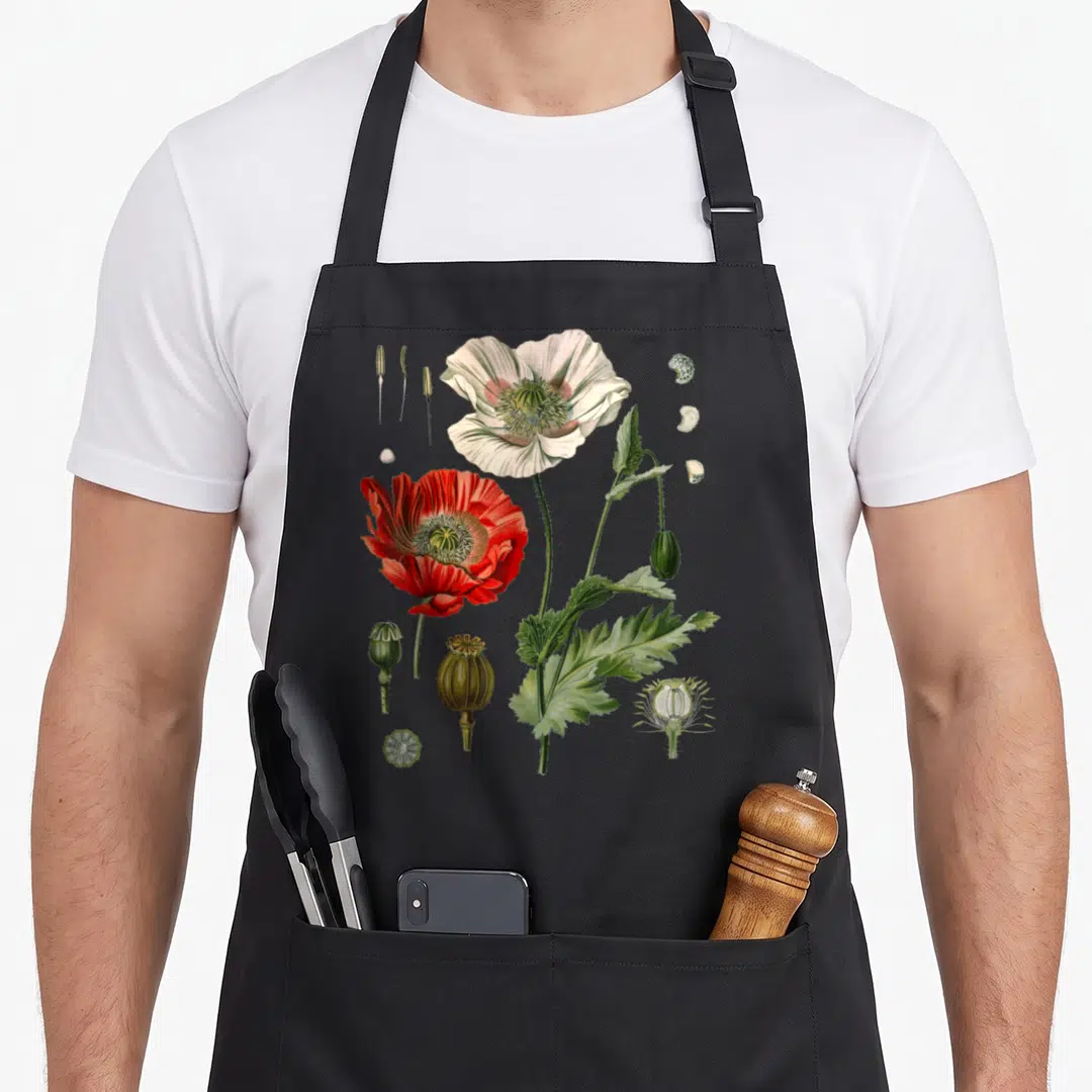 Botanical poppy apron - Realistic white and red poppy with seed pods and stamens in botanical illustration style — shown on a black cotton canvas apron against a white background