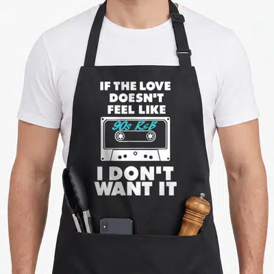 Funny feel r aprons - White cassette tape with cyan 90s R&B text and stacked white slogan lettering — shown on a black cotton canvas apron against a white background