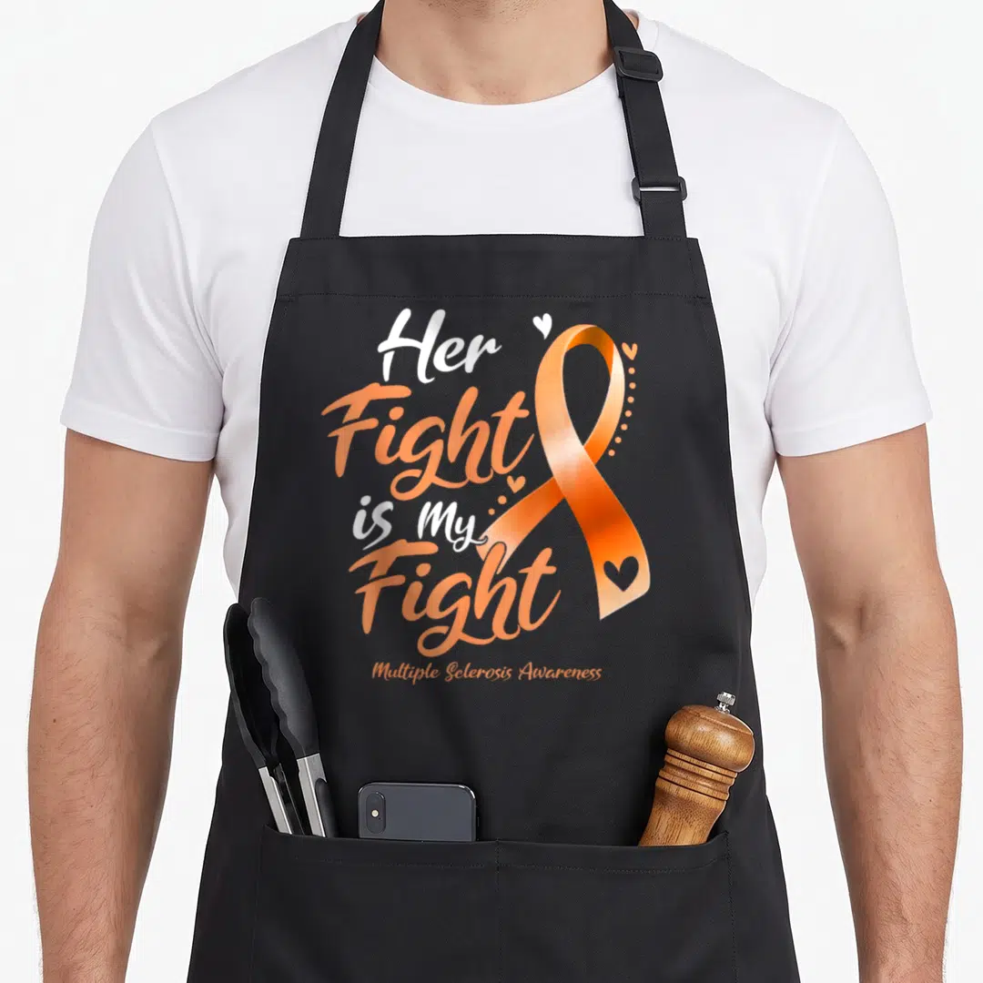 Multiple msemen apron - Her Fight Is My Fight text next to an orange ribbon with small white hearts — shown on a black cotton canvas apron against a white background