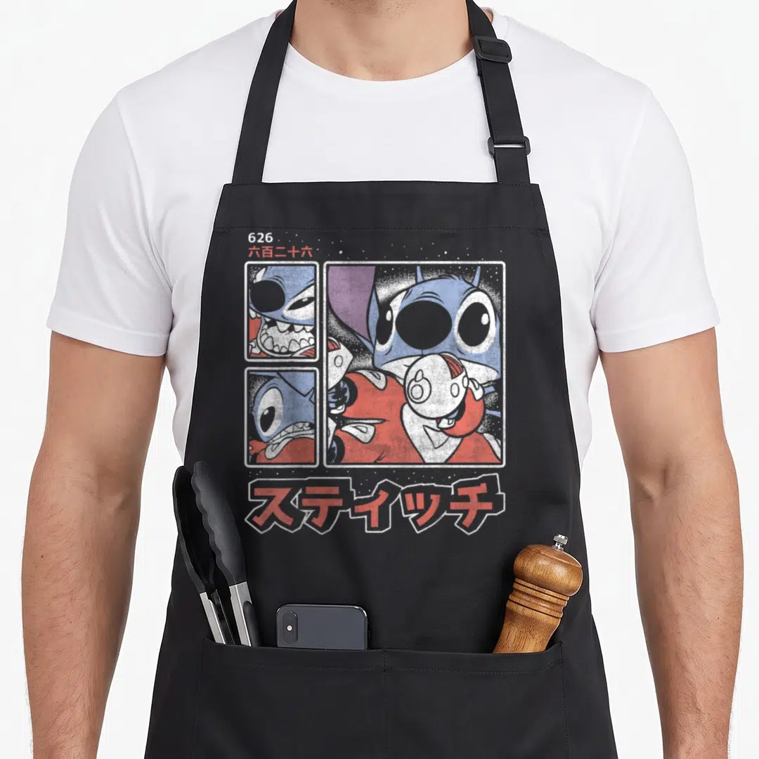 Kanji stitch apron - Three comic panels of Stitch with 626 and Japanese text in blue red white — shown on a black cotton canvas apron against a white background