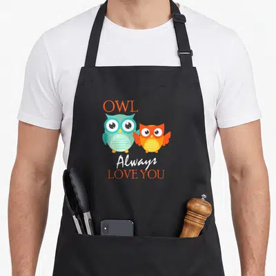 Alway owl apron - Two cartoon owls in orange and turquoise with text OWL Always LOVE YOU — shown on a black cotton canvas apron against a white background