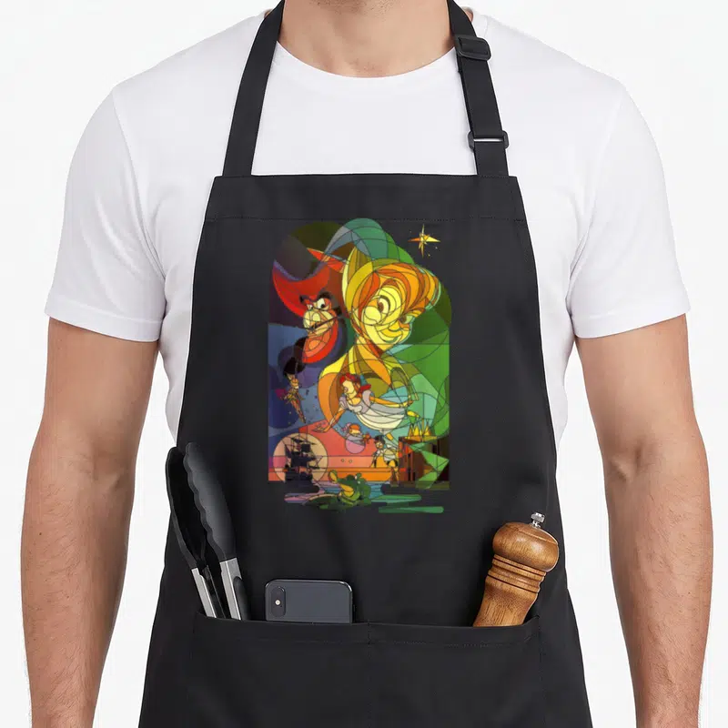 Peter stained apron - Stained glass style Disney characters in yellow green blue and red line art — shown on a black cotton canvas apron against a white background
