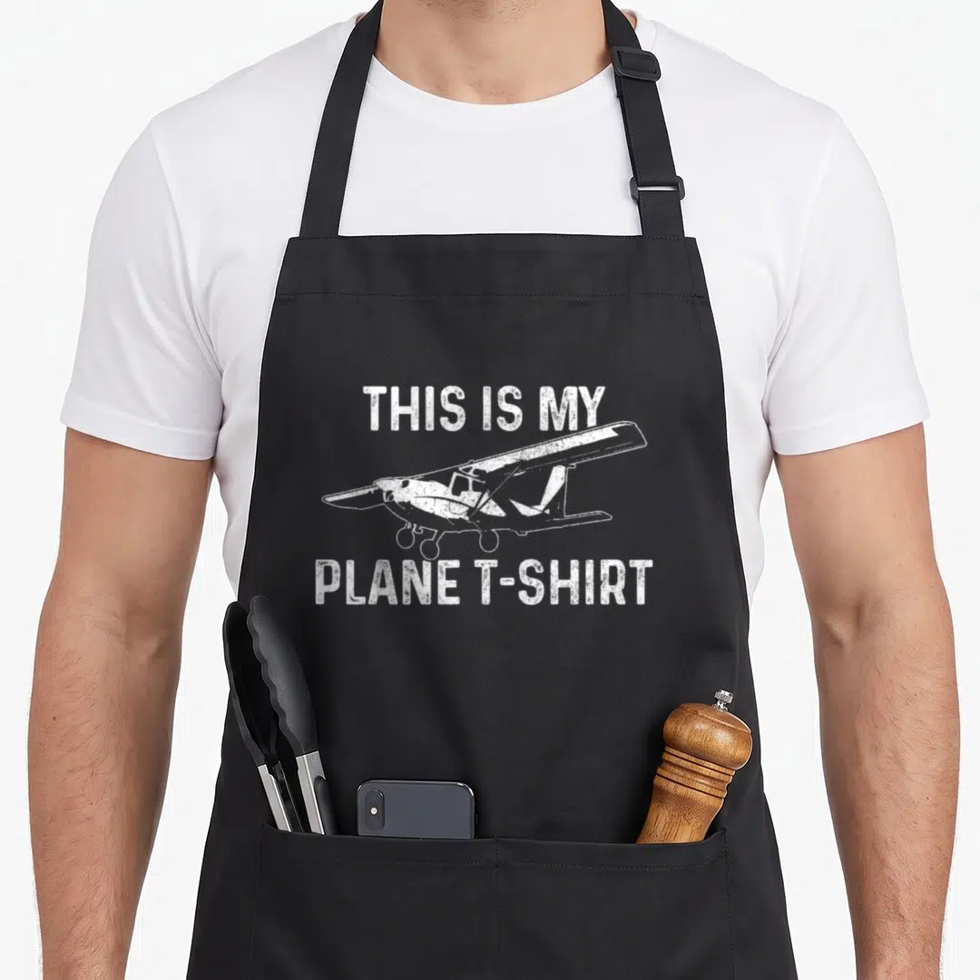 Aviation model airplane apron - White distressed airplane illustration between text reading THIS IS MY PLANE T-SHIRT — shown on a black cotton canvas apron against a white background