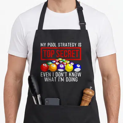 Player game aprons - Cartoon billiard balls under red top secret stamp with white quote text — shown on a black cotton canvas apron against a white background