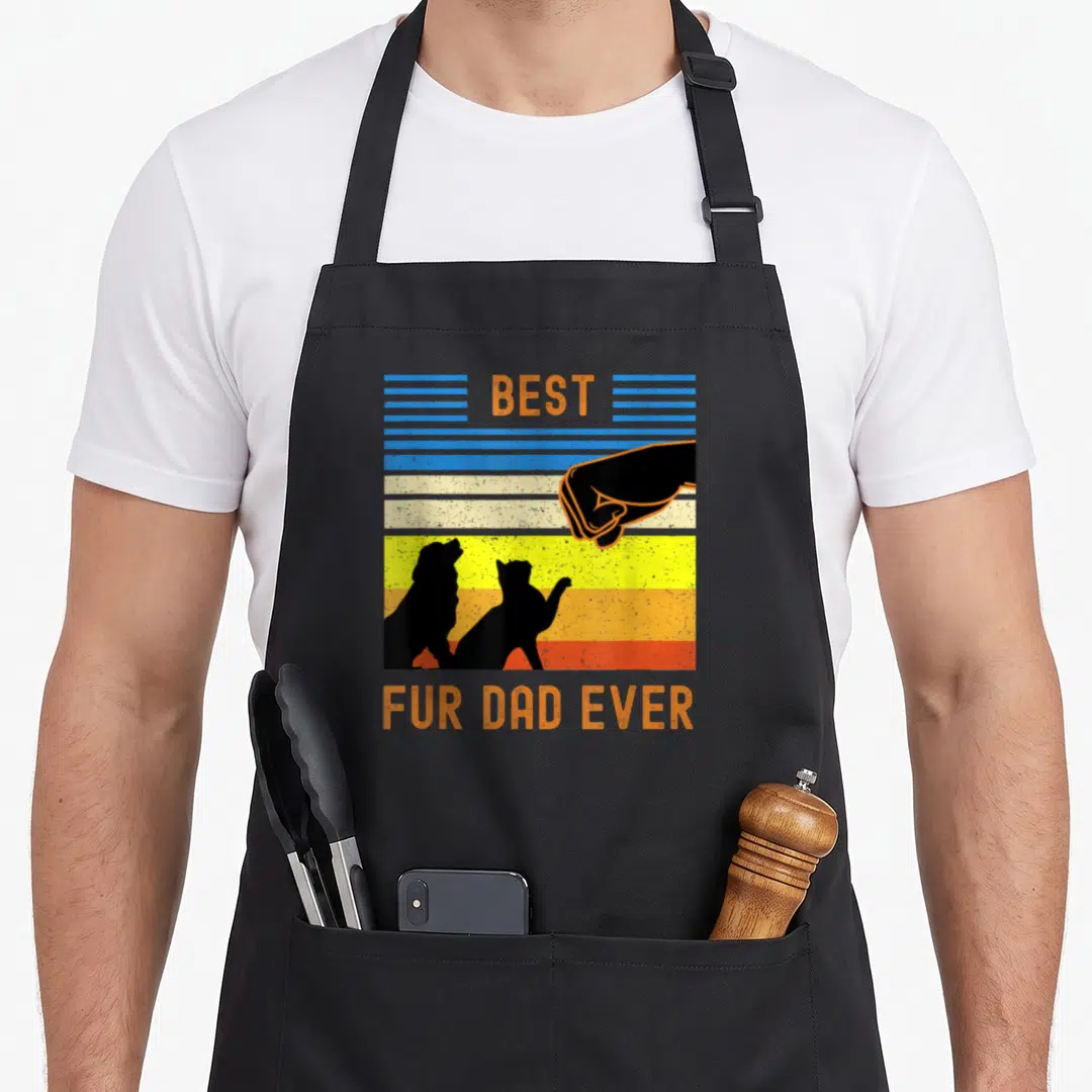 Fur dog owner funny cat aprons - Retro fist bump silhouette of hand dog and cat against striped background with Best — shown on a black cotton canvas apron against a white background