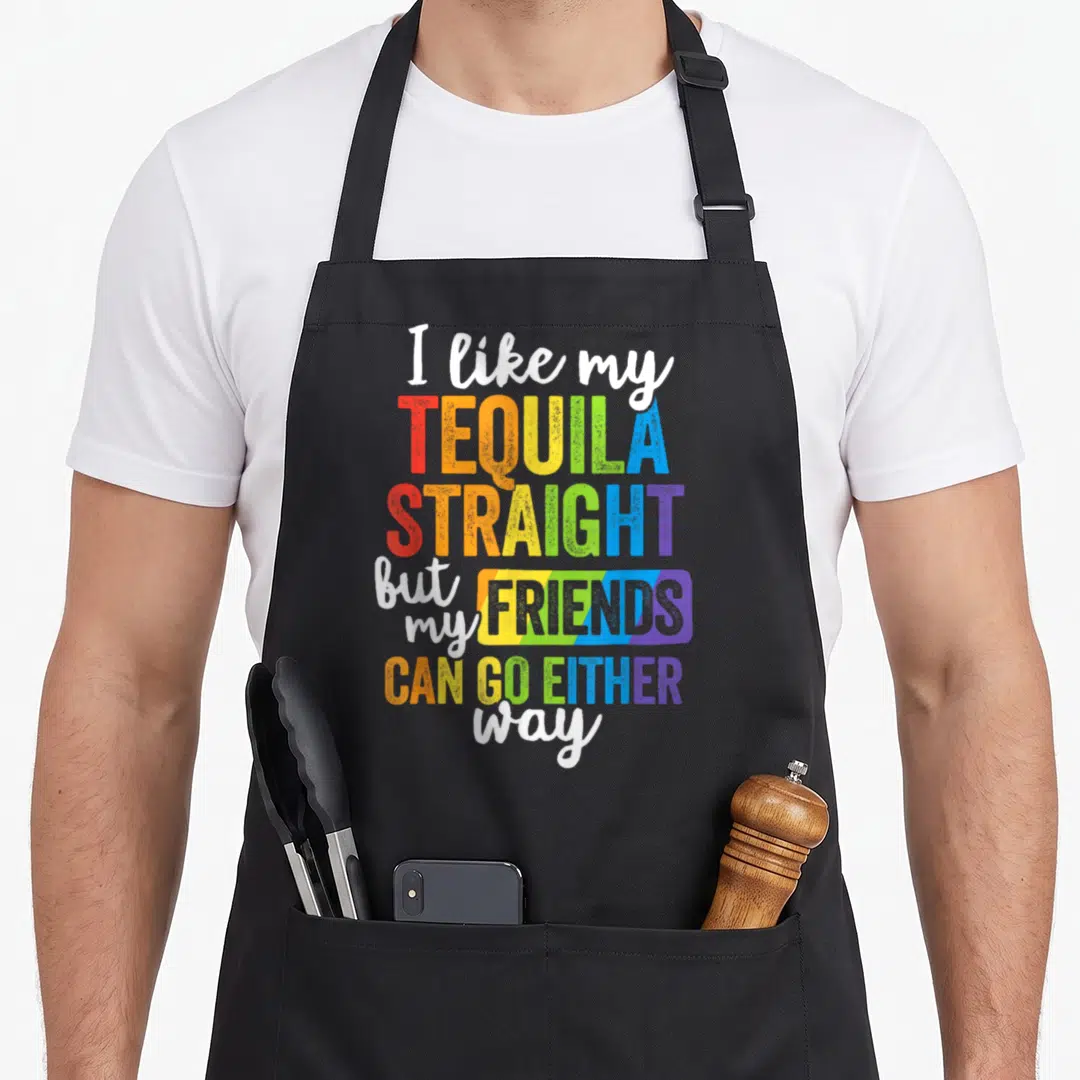 Lgbt friends apron - Rainbow typography reading I like my TEQUILA STRAIGHT but my FRIENDS CAN GO EITHER way — shown on a black cotton canvas apron against a white background
