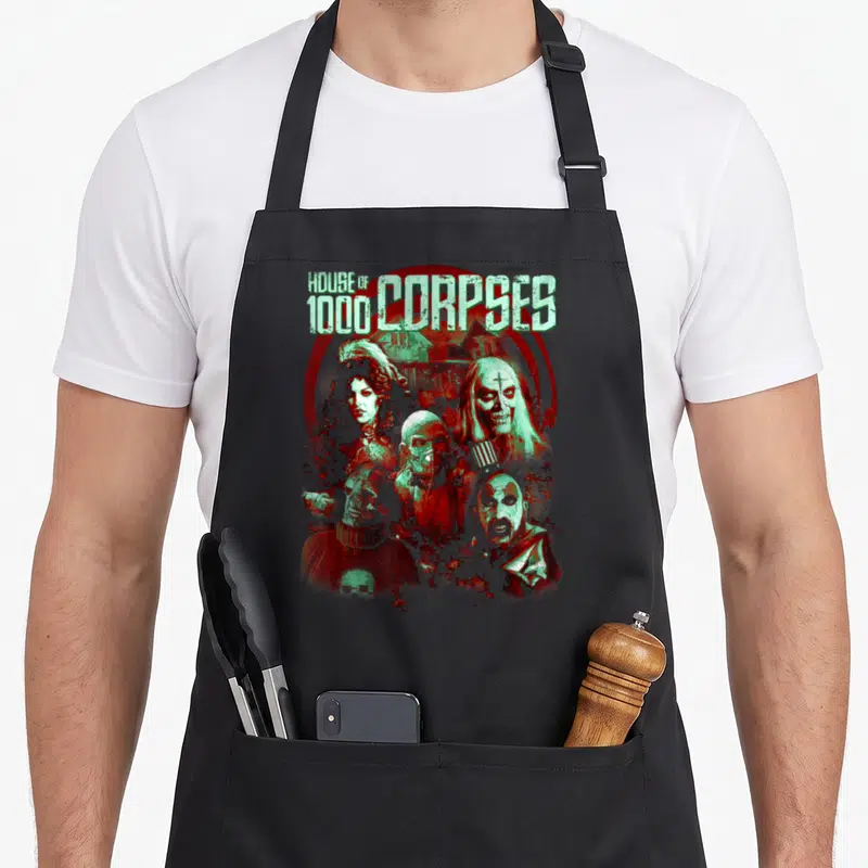Rob character aprons - House of 1000 Corpses text and five horror characters in red and mint green distressed art — shown on a black cotton canvas apron against a white background