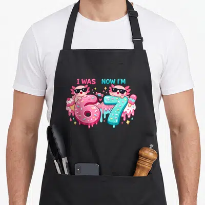 Axolotl meme apron - Two cartoon axolotls with sunglasses leaning on pink number 6 and blue number 7 surrounded — shown on a black cotton canvas apron against a white background
