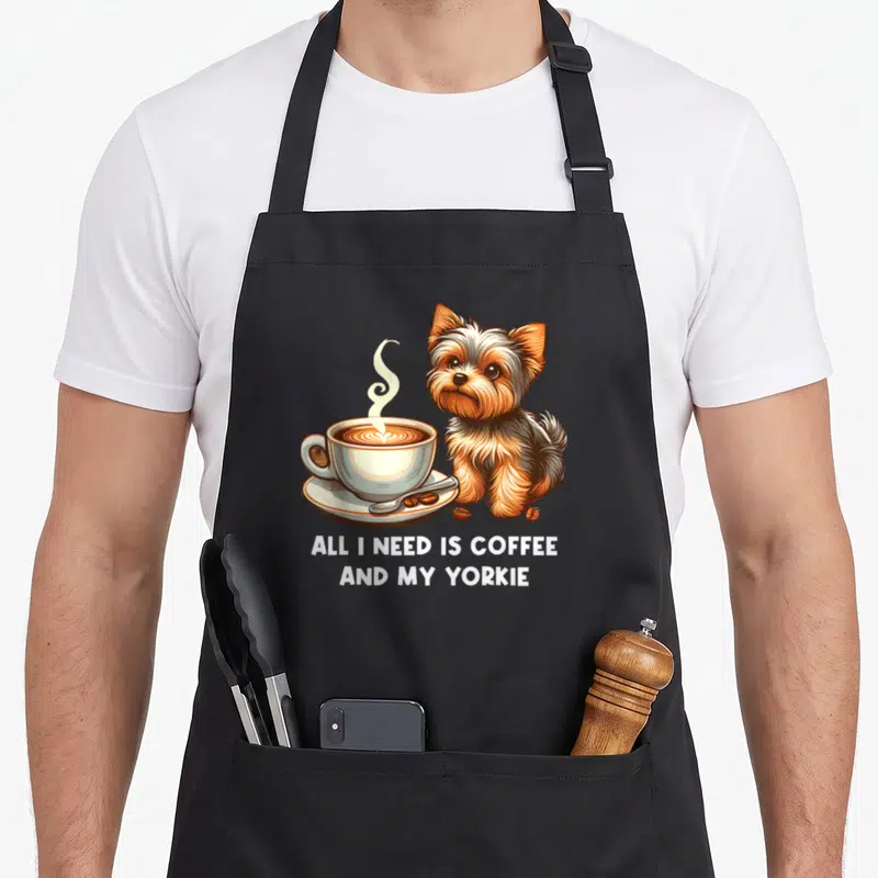 Yorkie mother's day aprons - Realistic brown and white yorkie sitting next to coffee cup with text below — shown on a black cotton canvas apron against a white background