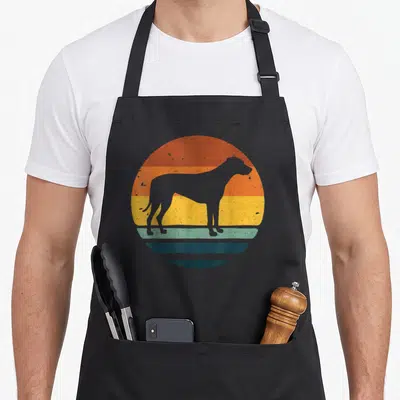 Rhodesian dog apron - Grey dog silhouette centered on a circle of orange, yellow, teal, and grey horizontal stripes — shown on a black cotton canvas apron against a white background
