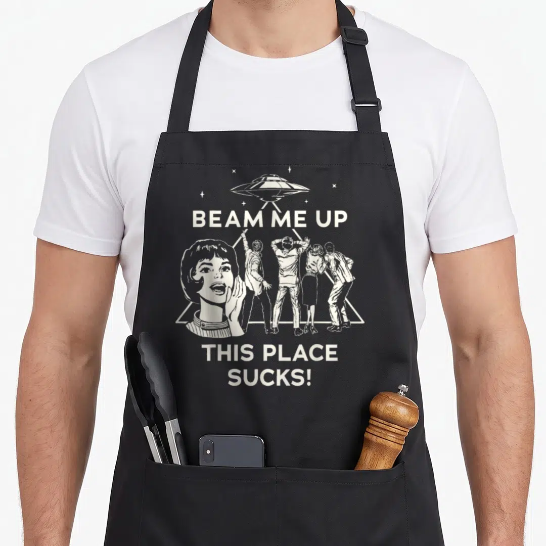 Beam stranger apron - Retro white UFO and four people in beam with text BEAM ME UP THIS PLACE SUCKS — shown on a black cotton canvas apron against a white background