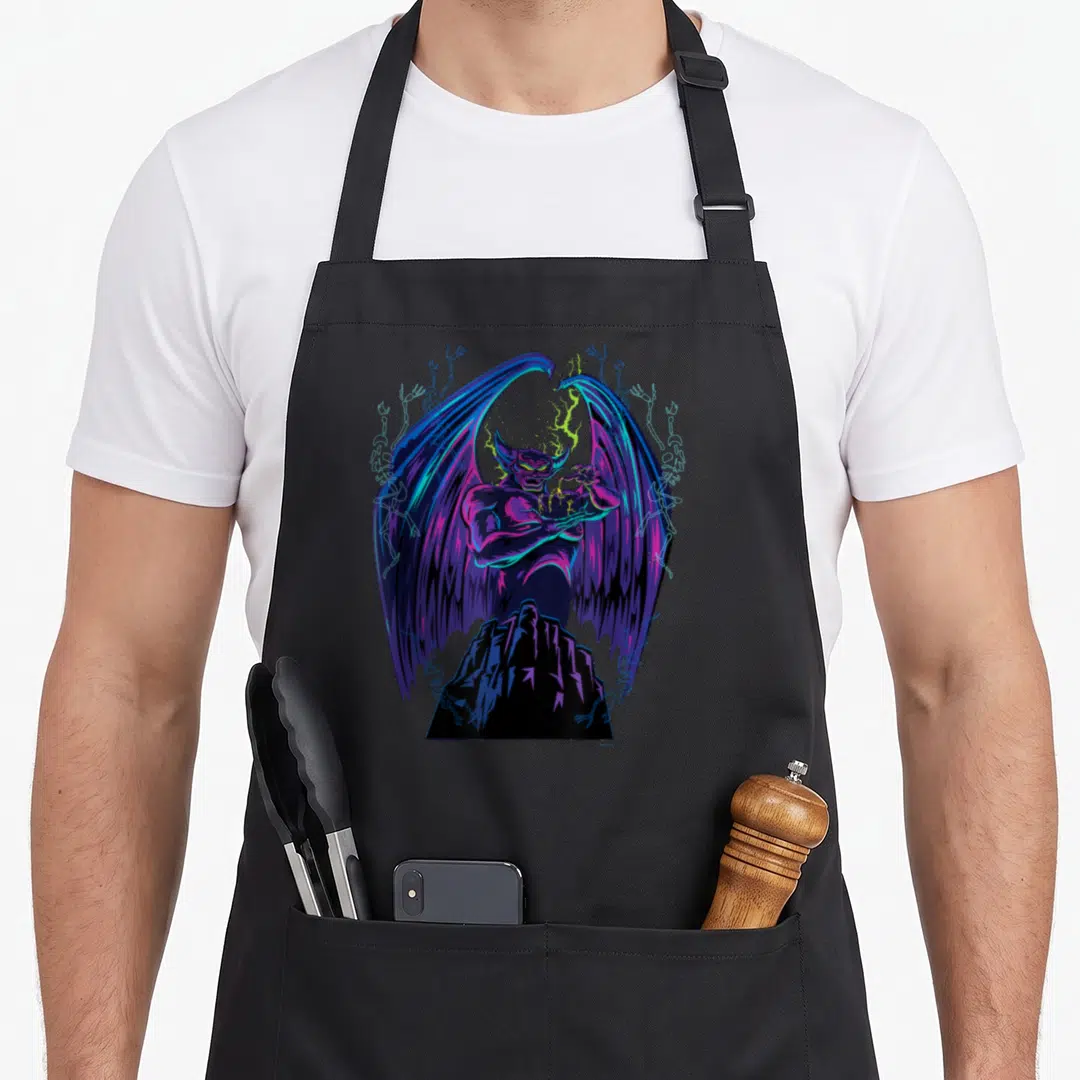 Chernabog novelty apron - Muscular demon with wings and lightning on jagged mountain with skeletons — shown on a black cotton canvas apron against a white background