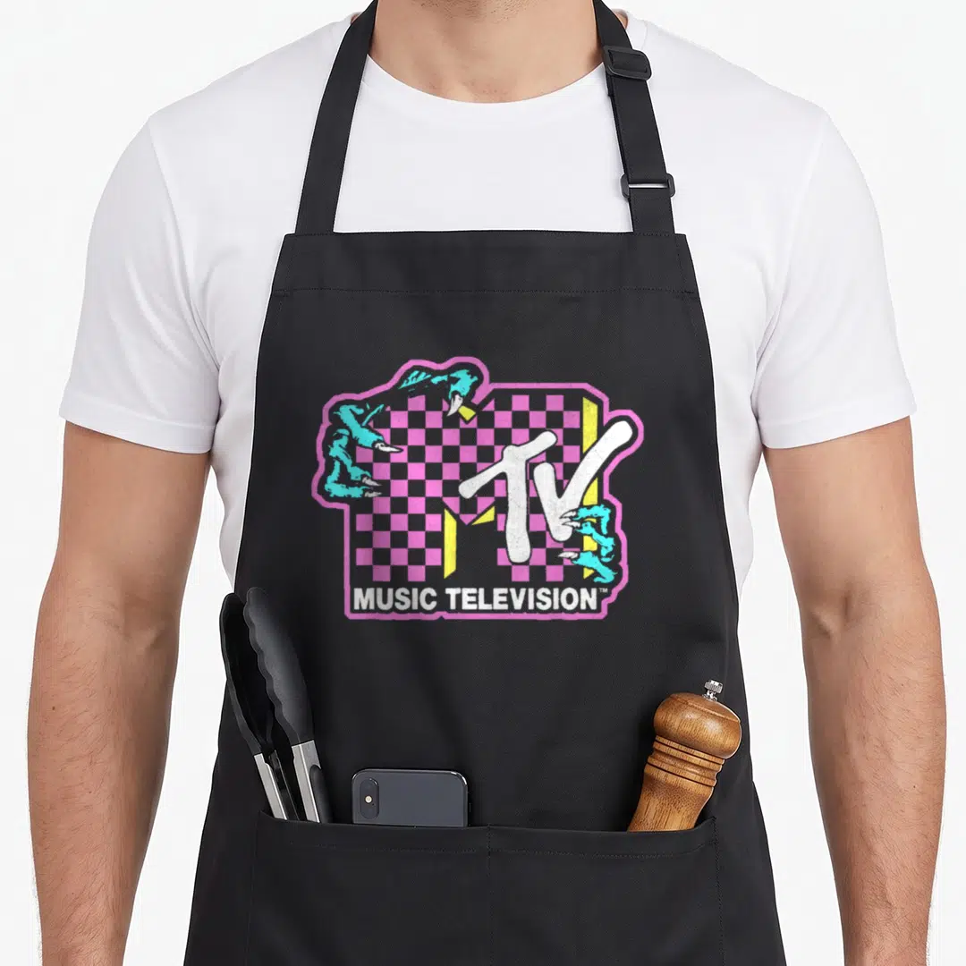 Mtv checkered apron - Pink checkerboard MTV logo gripped by teal monster claws with white text bar — shown on a black cotton canvas apron against a white background