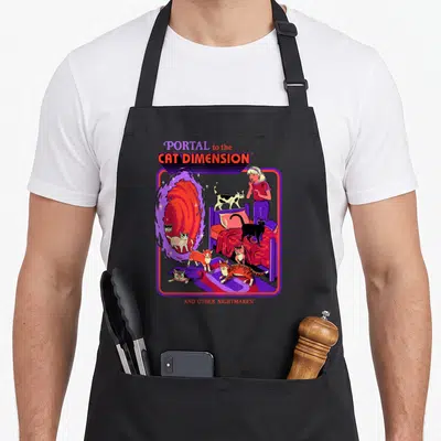 Steven cat apron - Cartoon woman and cats near swirling portal with purple border and red text — shown on a black cotton canvas apron against a white background
