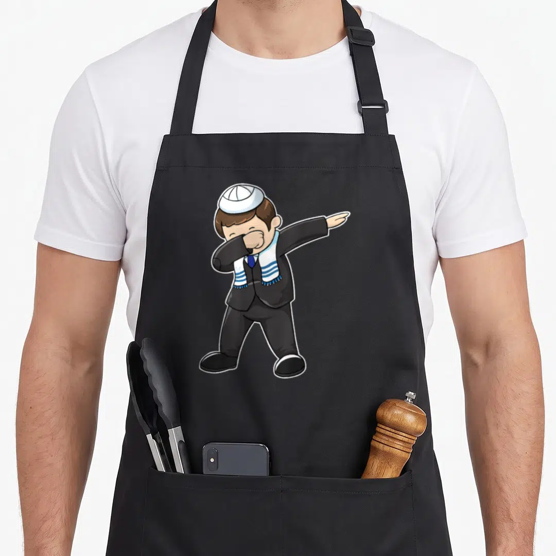 Bar hanukkah apron - Cartoon boy dabbing in black suit white kippah and blue striped shawl — shown on a black cotton canvas apron against a white background