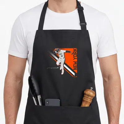 Soto new york aprons - Minimalist baseball player on orange background with white diagonal stripes and vertical NEW — shown on a black cotton canvas apron against a white background