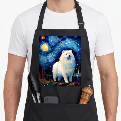 Surreal starry dog apron - White Samoyed dog standing in swirling blue night sky with yellow moon and stars — shown on a black cotton canvas apron against a white background