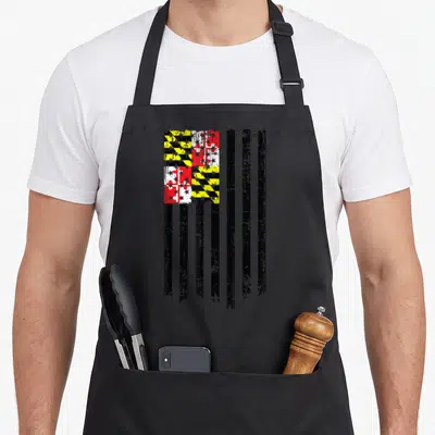 Maryland american flag apron - Distressed black yellow red white flag design with Calvert cross pattern and vertical — shown on a black cotton canvas apron against a white background