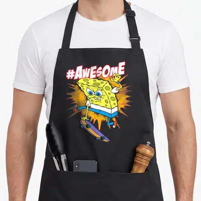 Squarepant cranberry sauce apron - SpongeBob on purple skateboard with #AwESOmE text and orange burst background — shown on a black cotton canvas apron against a white background