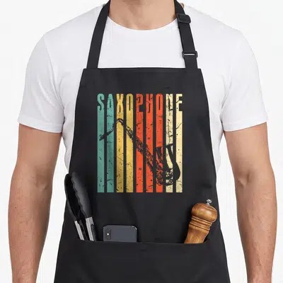 Vintage saxophone apron - Vertical SAXOPHONE text on teal yellow orange beige and grey stripes with a silhouette — shown on a black cotton canvas apron against a white background